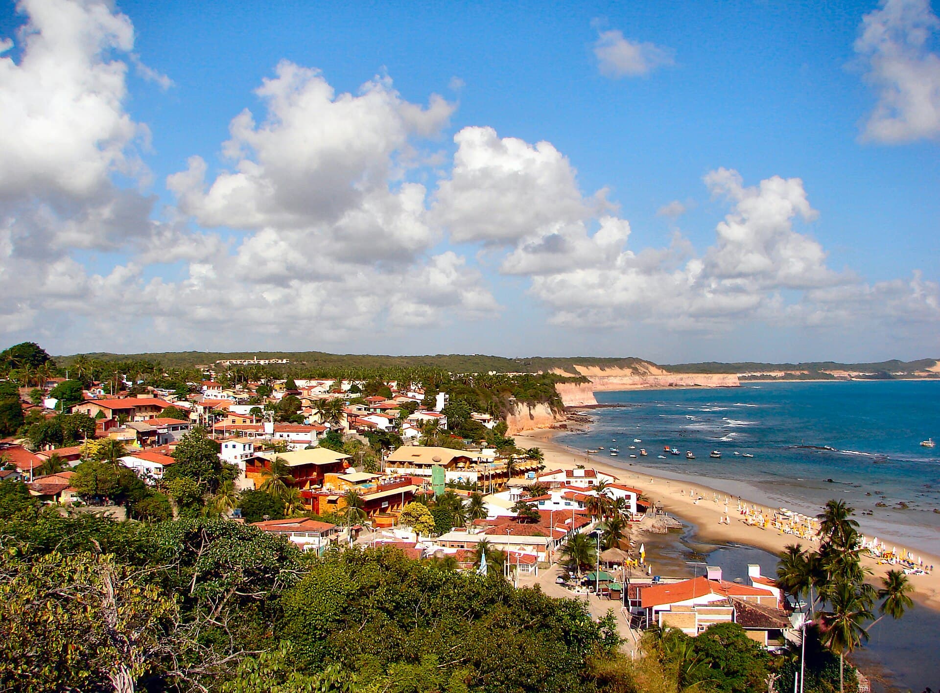 Pipa village and beach from the cliff above Praia do Amor — the cove-and-cliff geometry that defines Pipa.