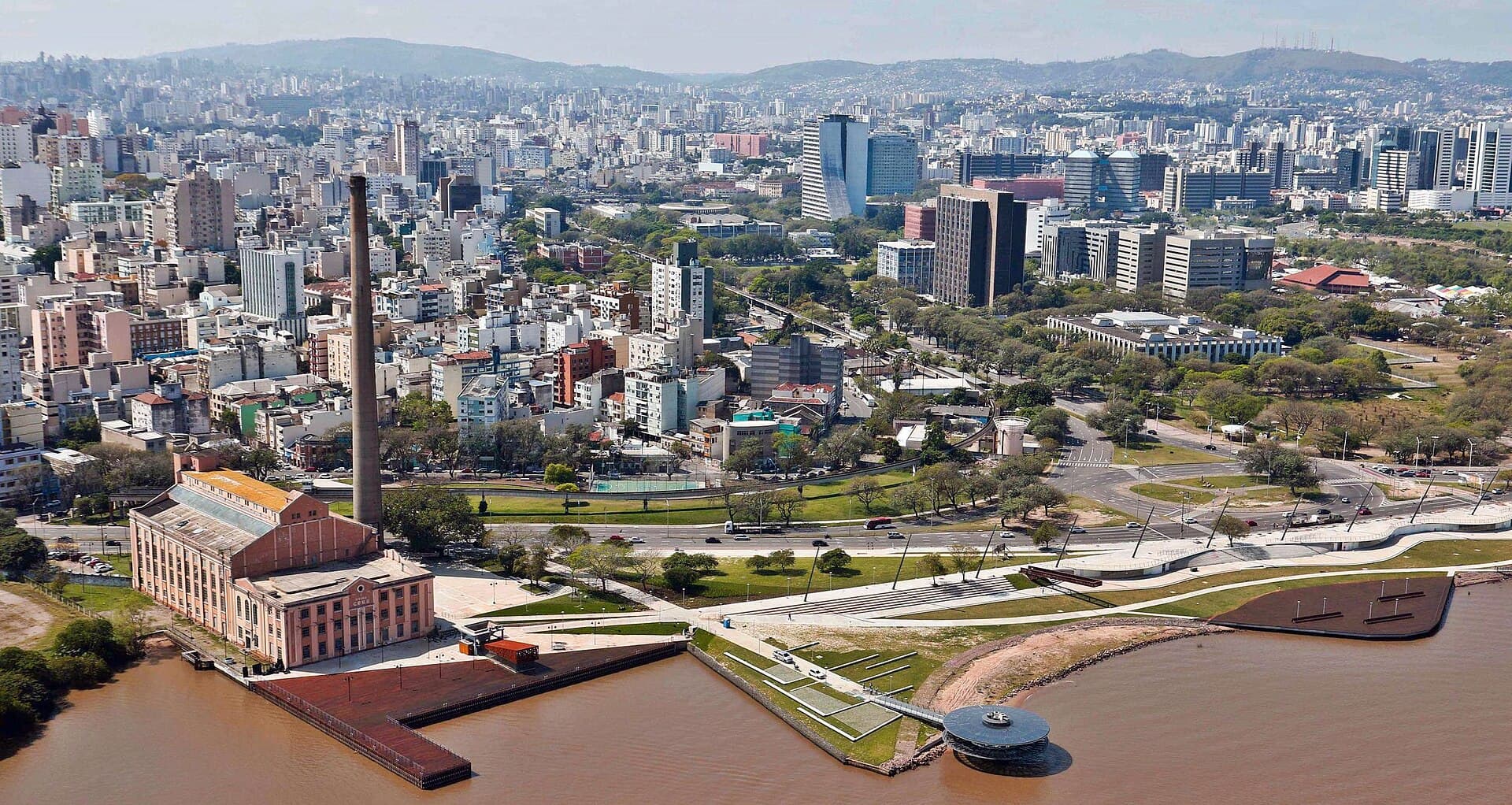 Aerial of Orla Moacyr Scliar along the Guaíba — the city's renewed waterfront where gaúchos gather for the famous sunsets.
